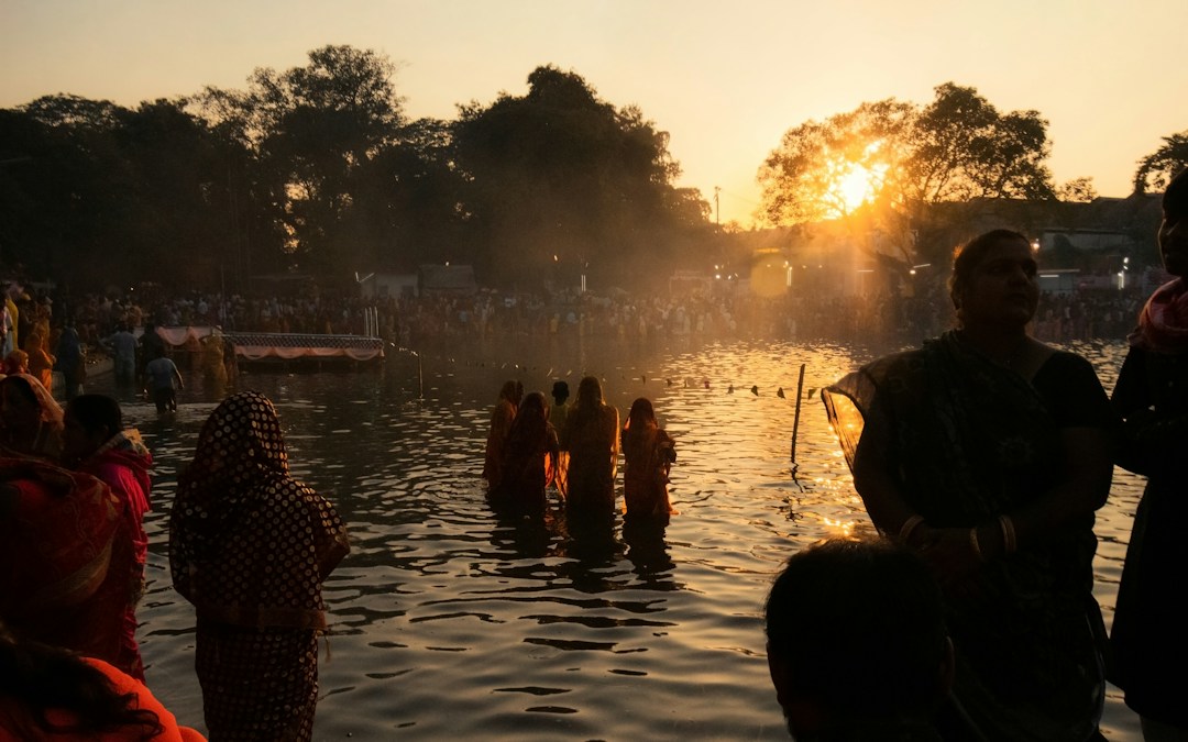 Devotees performing Sandhya Arghya during Chhath Puja at a river ghat
