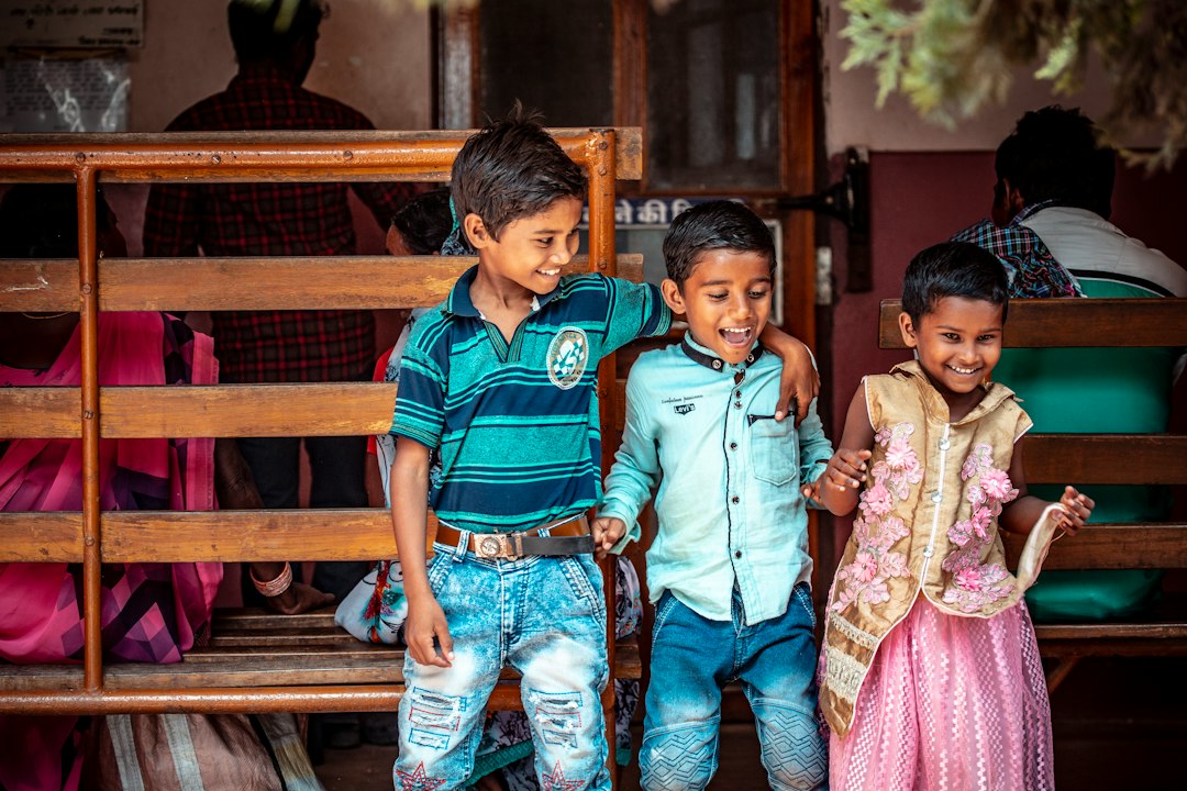 Child seated in a community setting, illustrative image for Child Helpline Supervisor recruitment