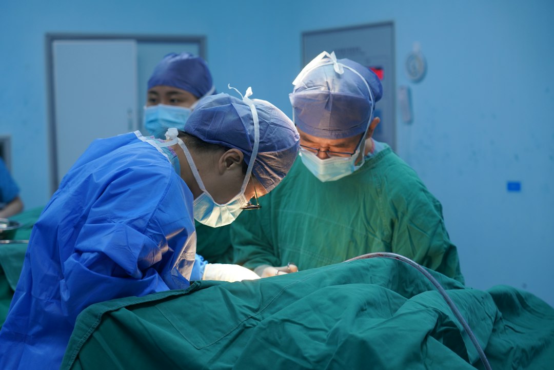 Surgeons in an operating room representing GI surgery faculty recruitment