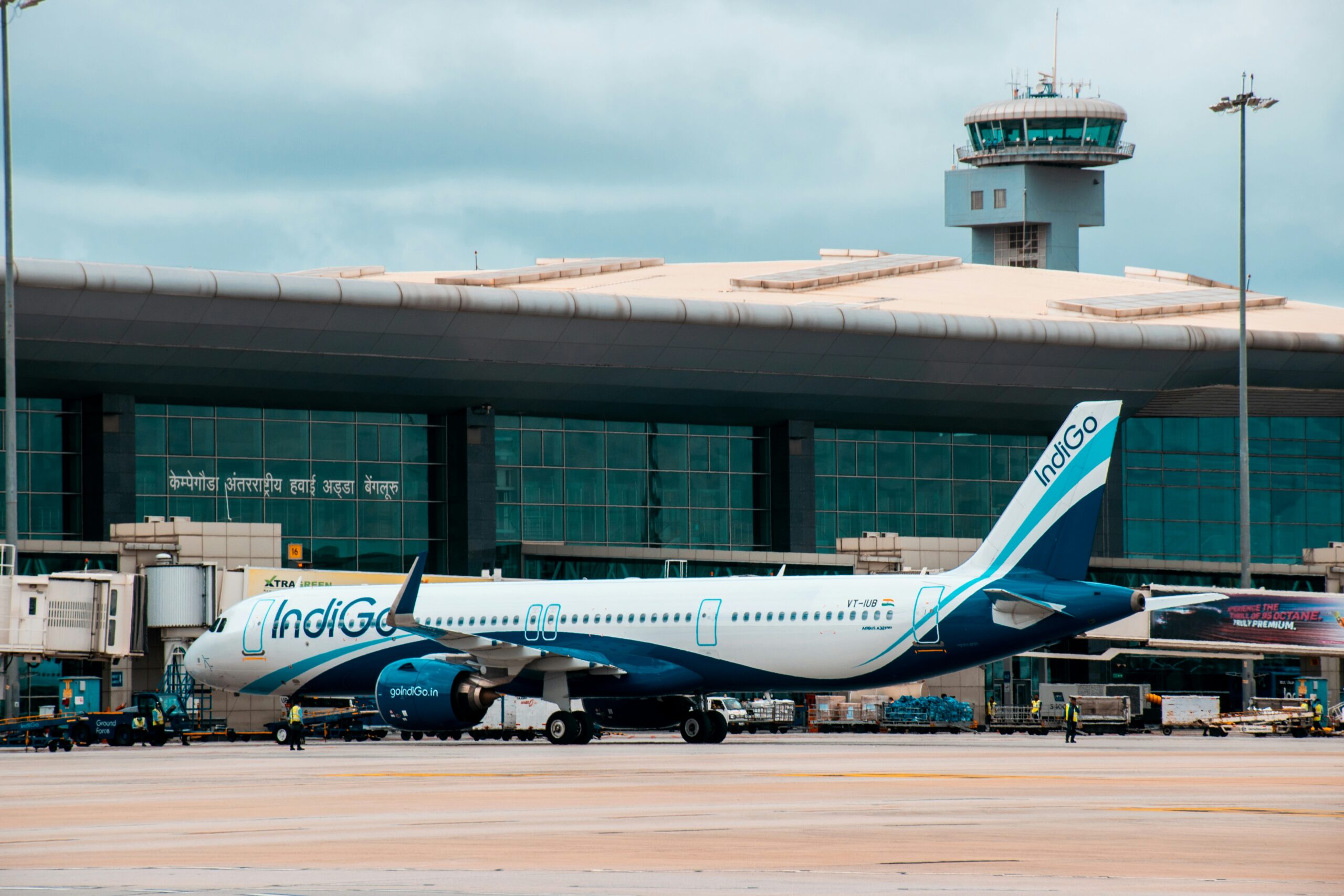 Airplane at an airport representing IndiGo fuel surcharge and flight fare changes