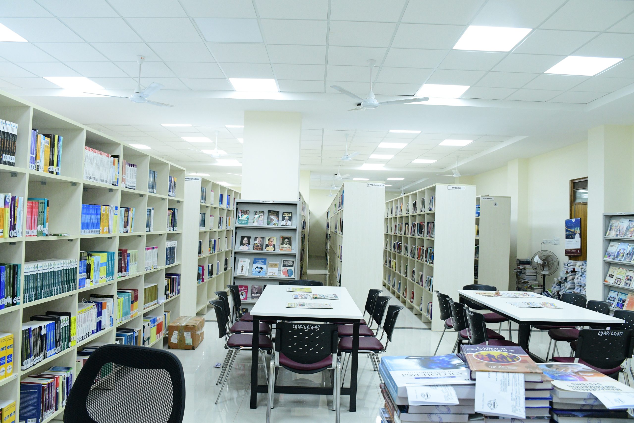 Academic library shelves and reading area representing Library Professional Trainee recruitment