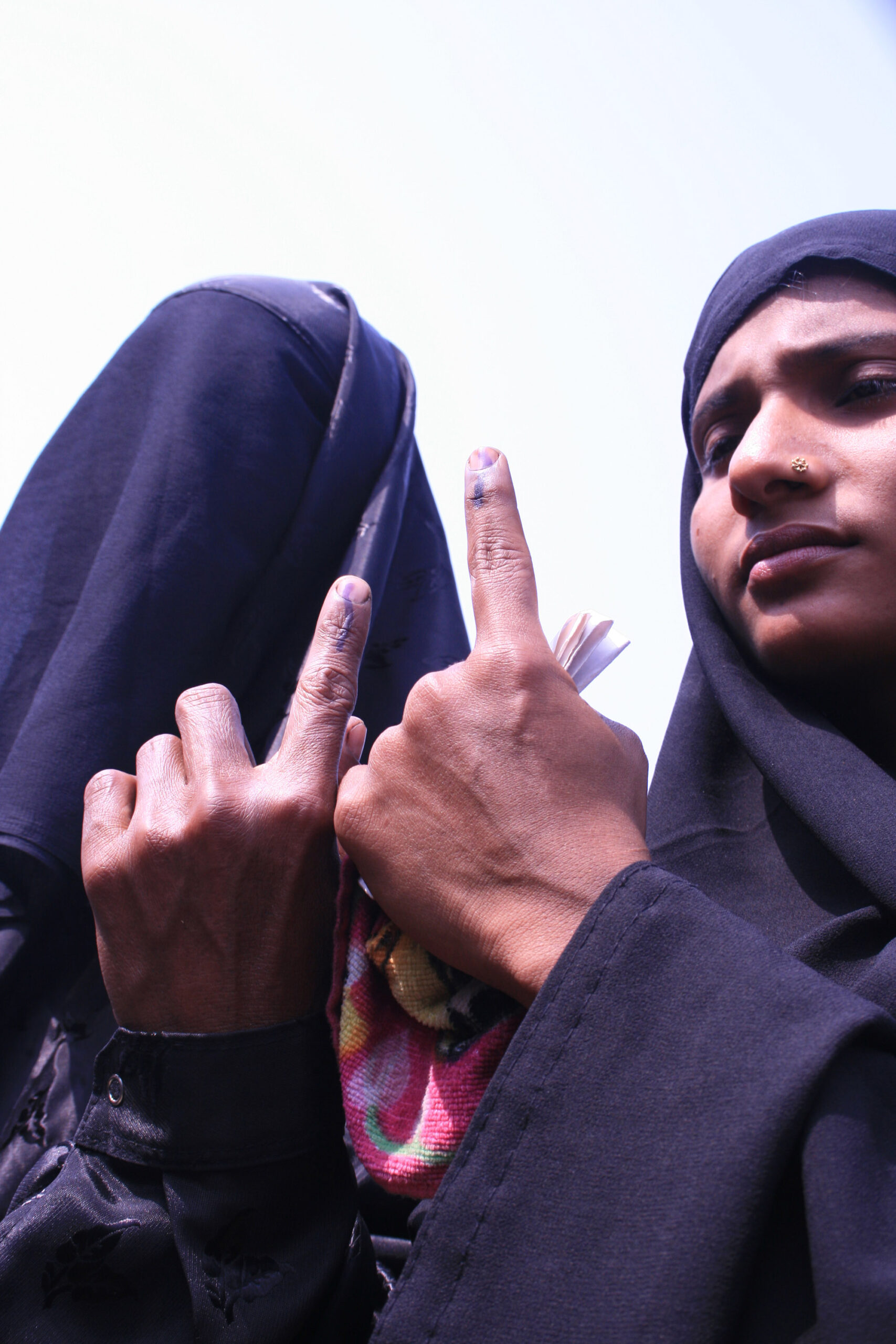 Voters showing indelible ink after voting in Nagaon district, Assam